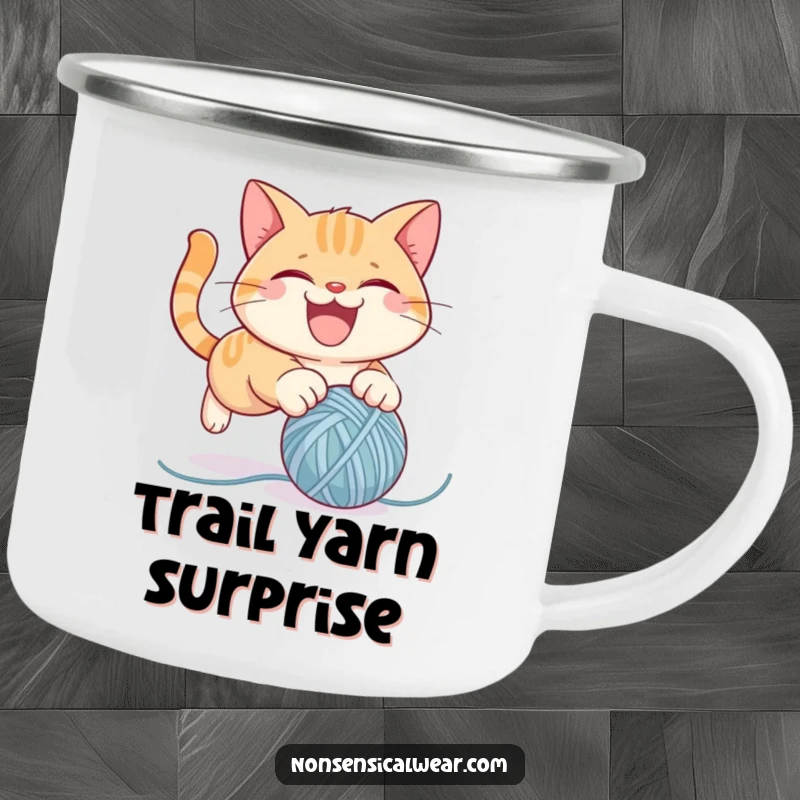 Funny camping mug featuring a mischievous cat character pouncing on a yarn ball, designed for outdoor fun and laughter.