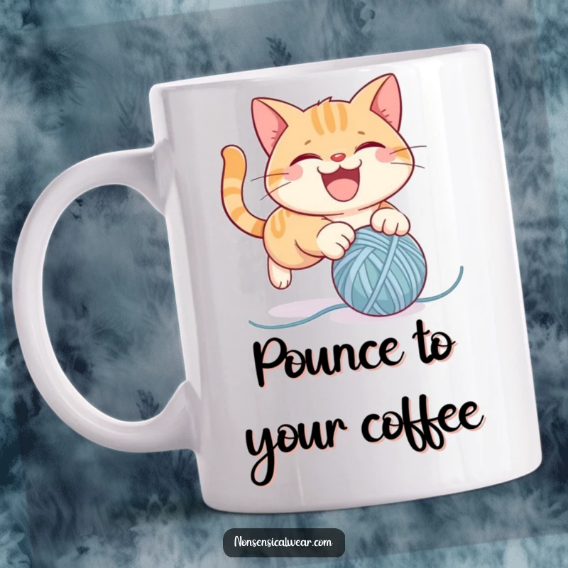 Funny cat mug featuring a mischievous cat character gleefully pouncing on a bouncing ball of yarn, captured in a moment of playful chaos.