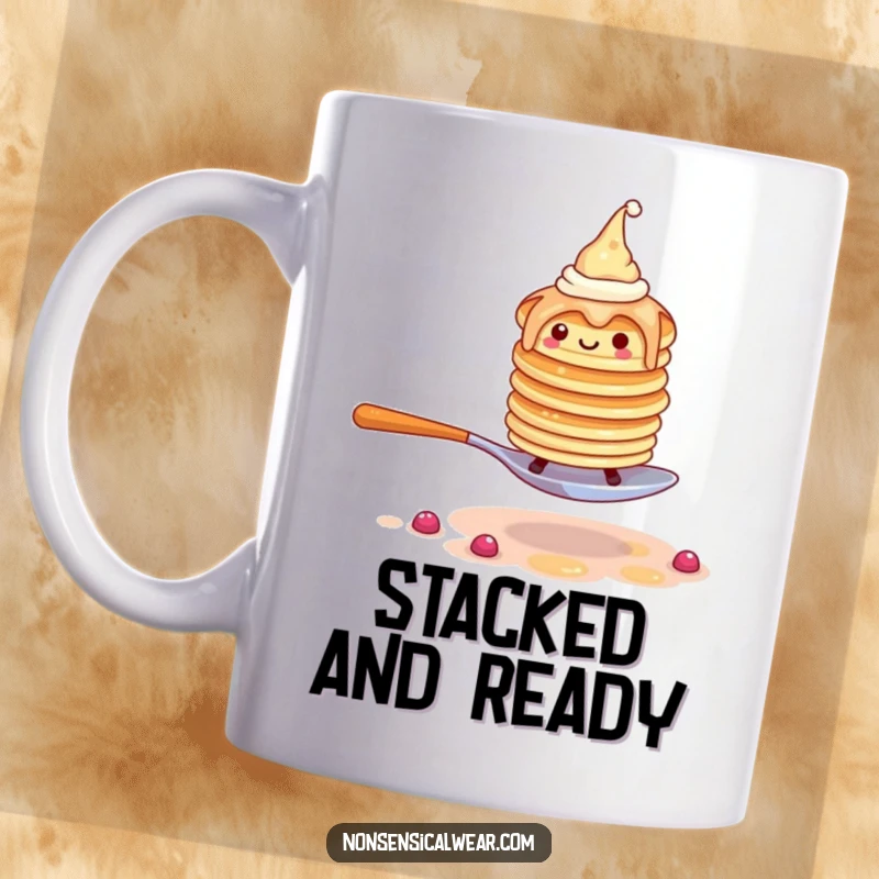 Funny pancake mug with a wobbly stack wearing tiny hats, attempting to walk on a spoon, looking unsteady.