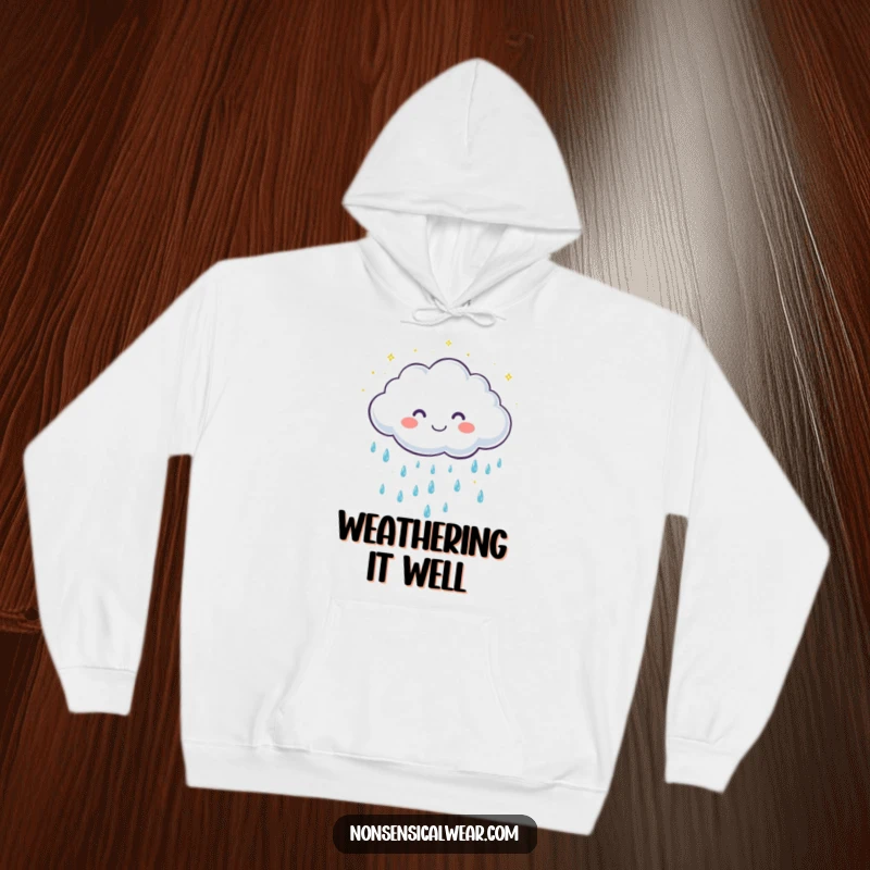 Funny hoodie featuring a cute, smiling cloud character showering down gentle, sparkling raindrops, offering cozy and cheerful vibes.