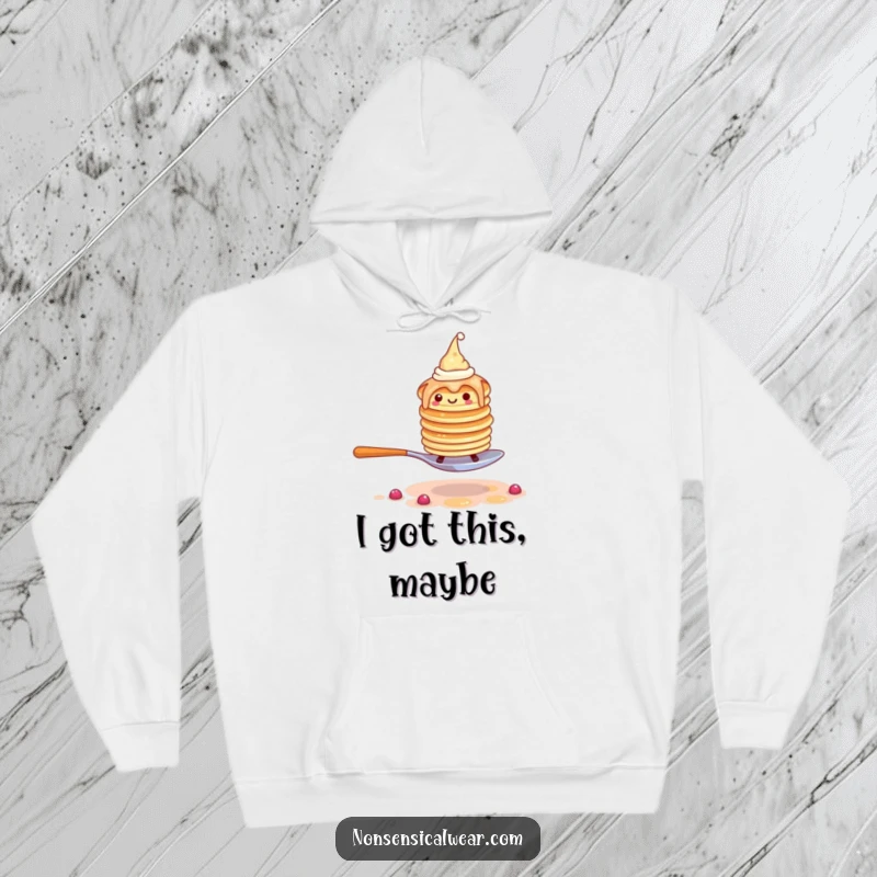 Funny pancake hoodie featuring a wobbly stack of pancakes in tiny hats attempting to walk on a spoon, looking determined.