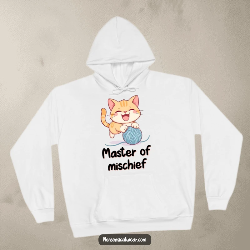 Funny hoodie showcasing a mischievous cat character energetically pouncing on a ball of yarn, ideal for cat lovers and comfort seekers.