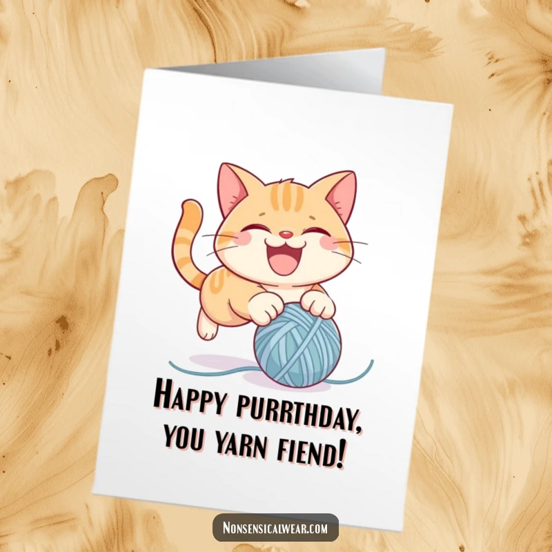 Funny Free Printable Cat Birthday Card showing a mischievous kitty gleefully attacking a bouncy ball of yarn, ready for birthday chaos.