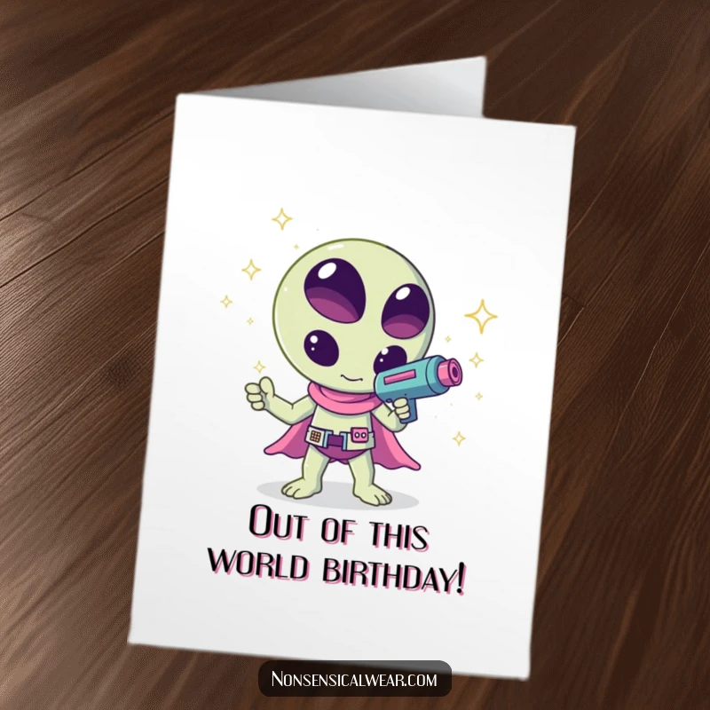 Funny Free Printable Birthday Card: A kawaii alien waves a ray gun shooting colorful sparkles, celebrating a birthday with cosmic flair.