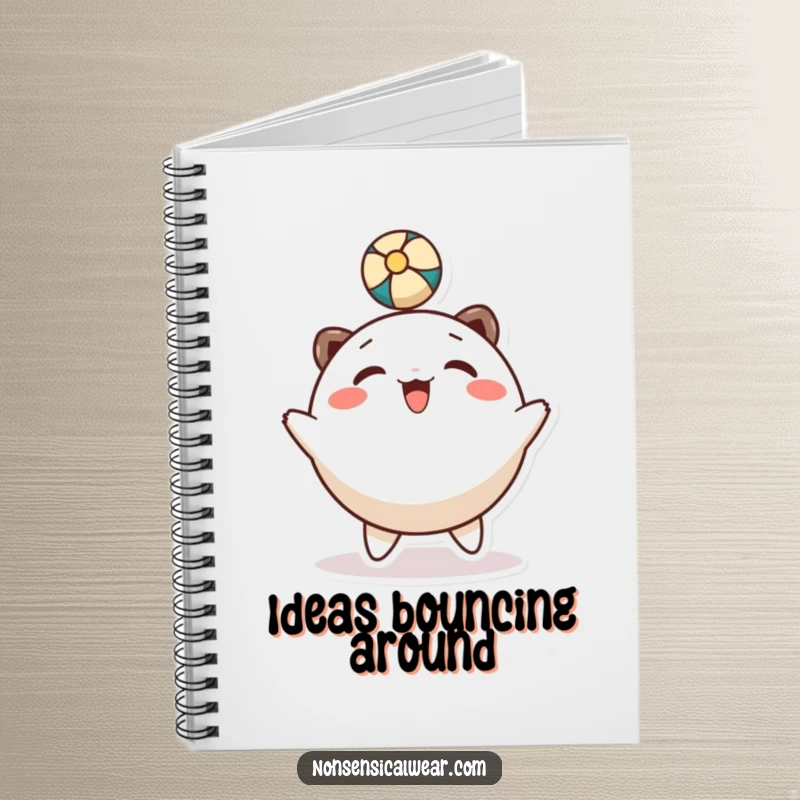 Funny notebook: a round, smiling character gleefully bounces a ball with its head, ideal for writing.