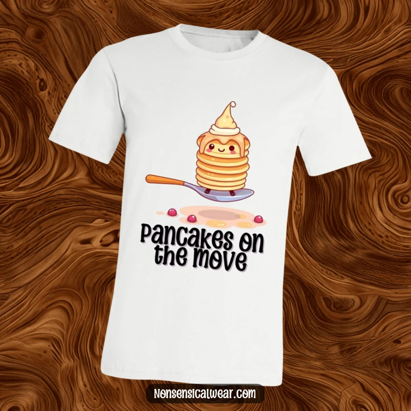 Funny t-shirt graphic of a wobbly stack of pancakes wearing tiny hats, precariously walking on a spoon.