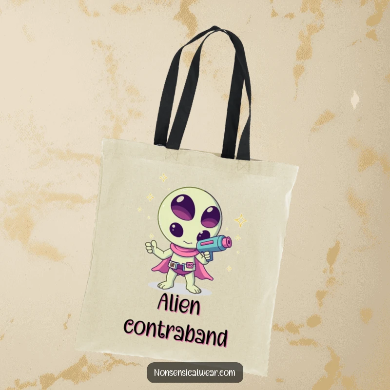 Funny kawaii alien waving a ray gun shooting sparkles, a humorous and creative design on this tote bag, great for shopping.